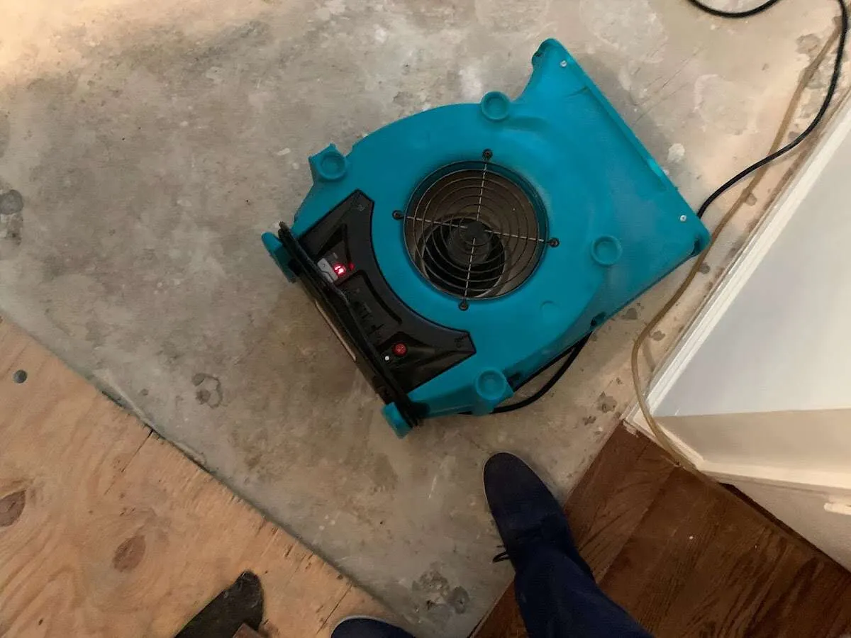 Air mover drying subfloor during Commercial Water Damage Restoration in Bartlesville